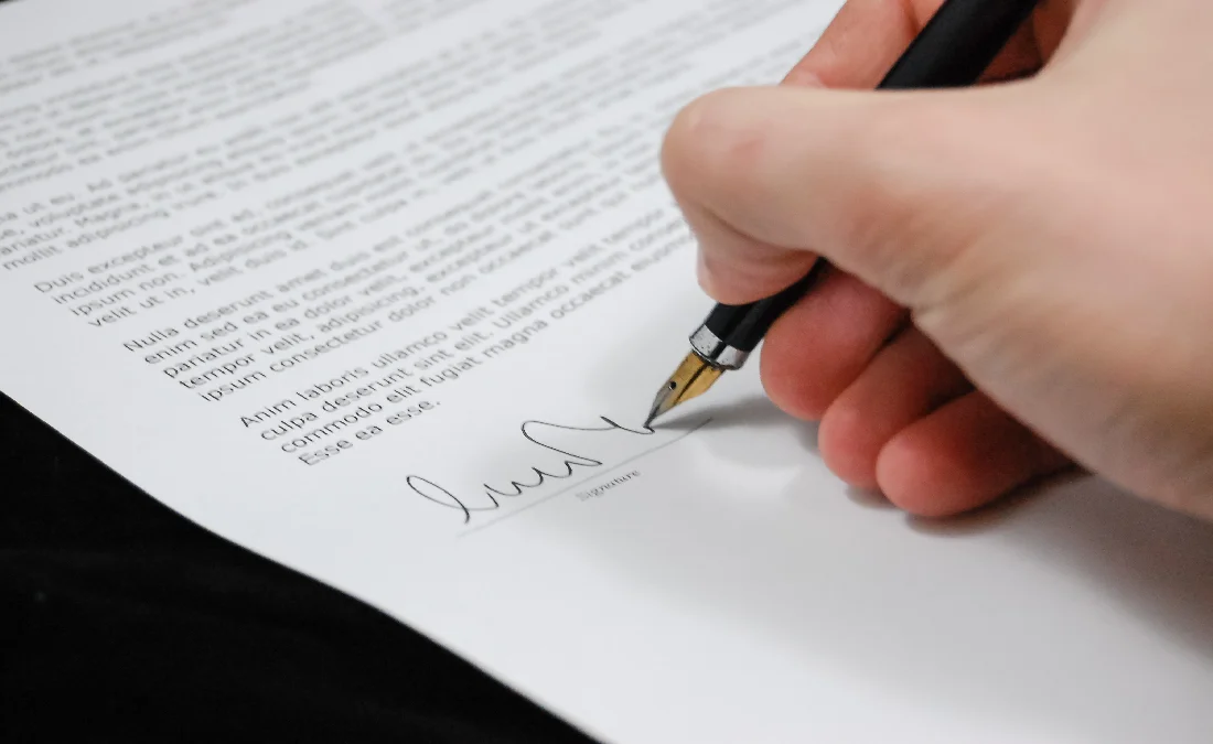 Lawyer signing contract for client