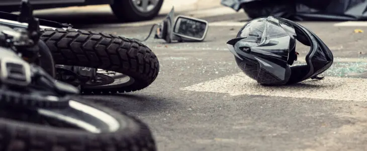 Motorcycle and helmet on the street after dangerous traffic incident