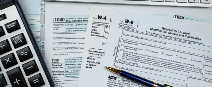 2022 blank 1040 us tax form with calculator and keyboard on office desk. Financial accounting concept